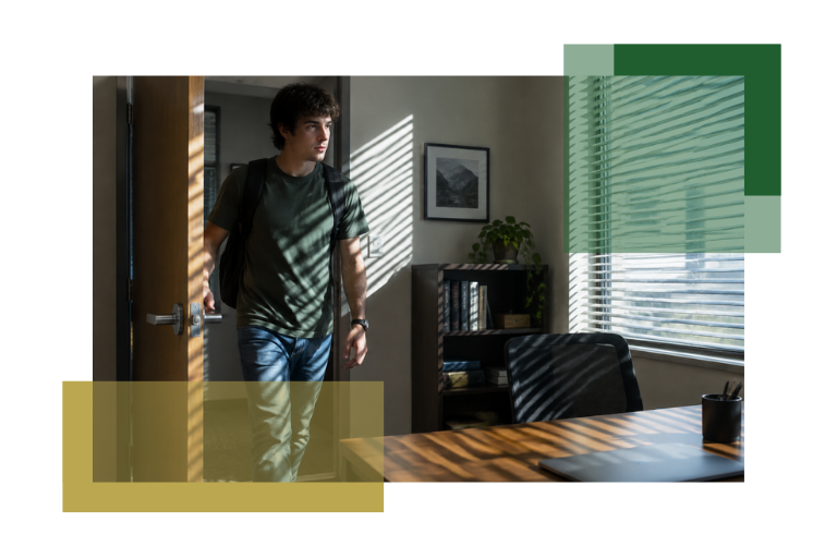 A young man with a backpack enters a sunlit office, casting striped shadows from window blinds across the room and his figure. The office has a desk, shelves, and framed artwork on the wall.